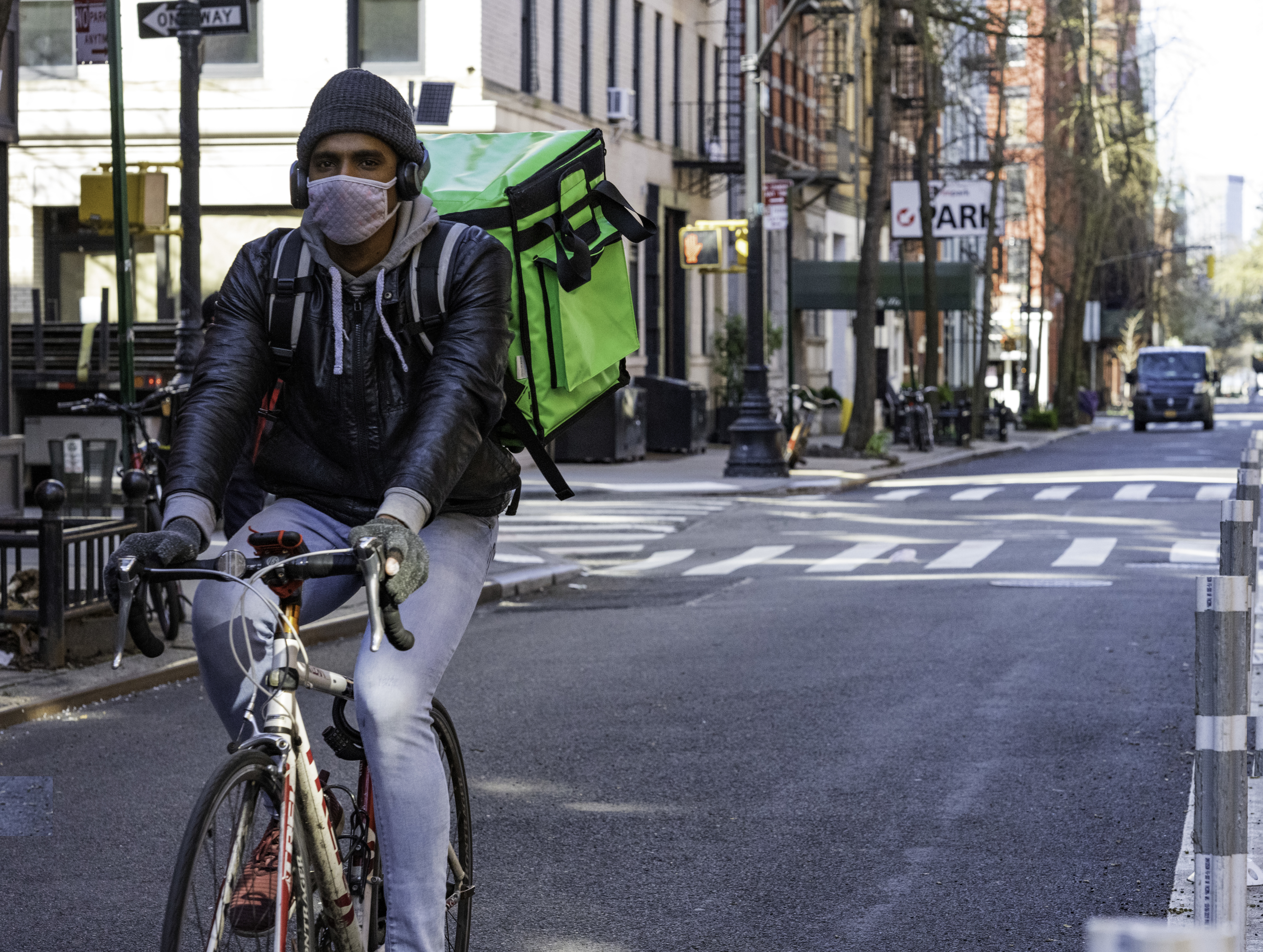 Delivery Man in Mask on bike